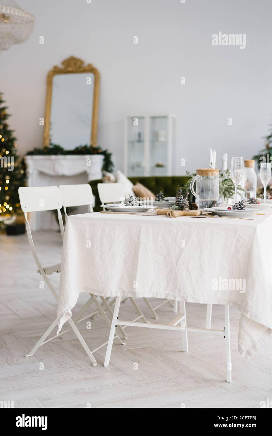 Christmas holiday beautifully set table in a spacious bright dining room or living room in the house Stock Photo