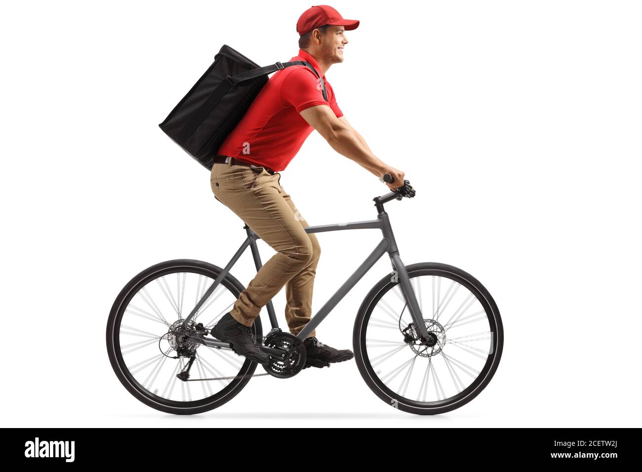 Food delivery guy in a red t-shirt delivering food with a bicycle isolated on white background Stock Photo