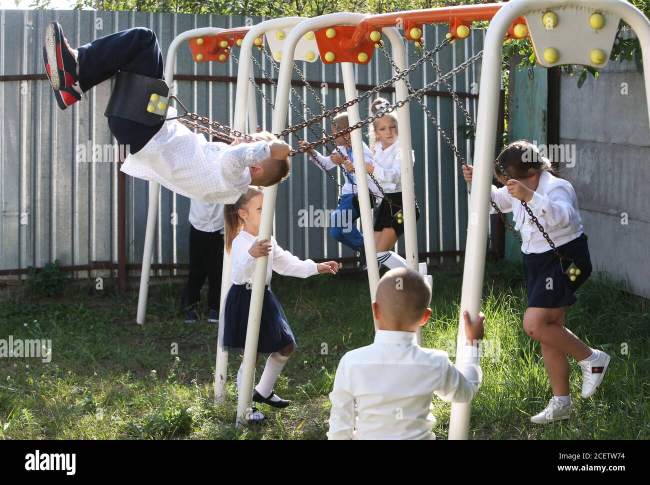 Kiev, Ukraine. 1st Sep, 2020. First graders play on swings at a school in Kiev Oblast, Ukraine, Sept. 1, 2020. Over 4.2 million students have resumed their studies in Ukraine, including 428,000 first-graders, as the country marks the start of the new school year. Children from the 21 cities and districts in 'red' quarantine zones will not return to school in person, instead studying remotely until the epidemiological situation changes. Credit: Sergey Starostenko/Xinhua/Alamy Live News Stock Photo