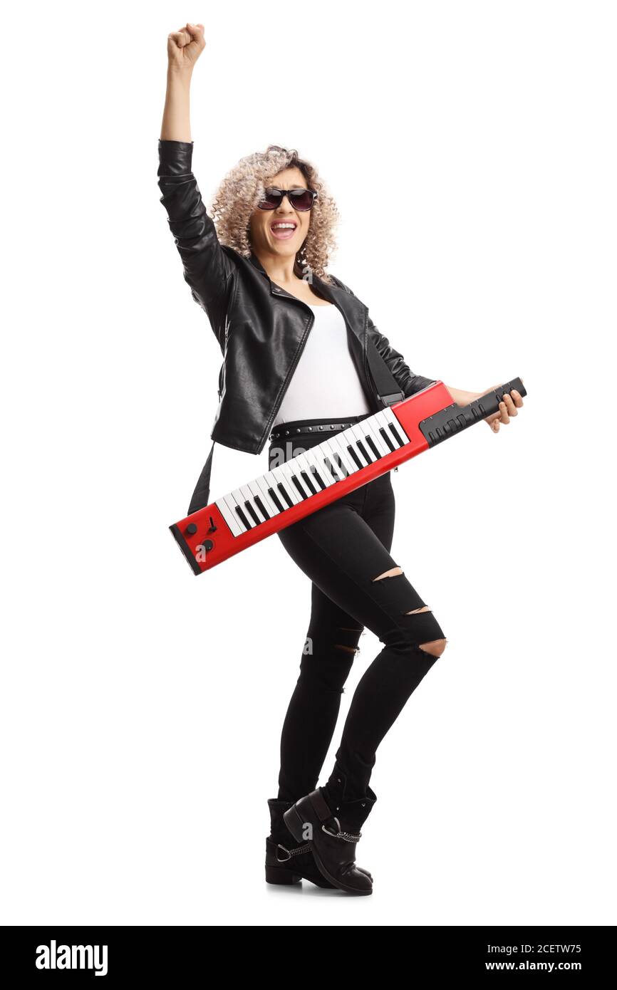 Full length portrait of a female musician with a keytar wearing sunglasses and gesturing with hand isolated on white background Stock Photo
