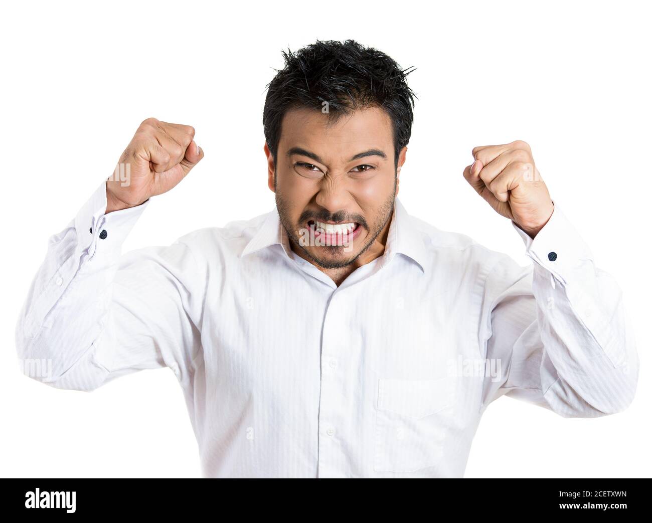 Portrait of an angry man with hands in air, wide open mouth yelling, isolated white background. Negative emotion, facial expression feelings. Stock Photo