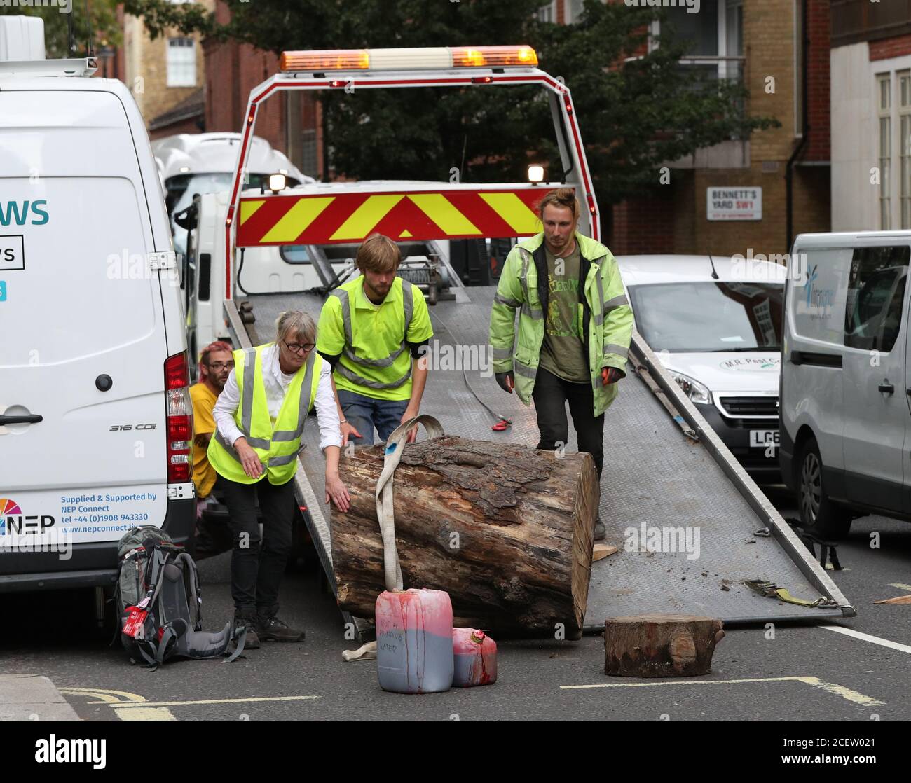 Extinction Rebellion protesters unload a large wooden block and fake blood from a vehicle outside the Home Office in Marsham Street, Westminster, London. Stock Photo