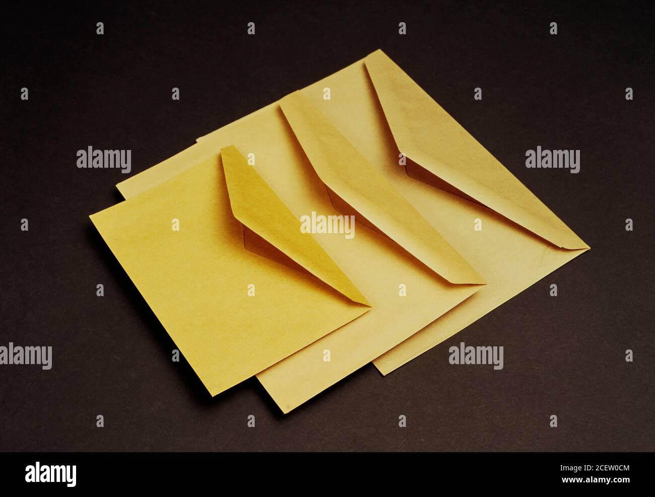 Examples of different sizes of yellow envelopes to send letters, paperwork, and so on. Envelopes used for mail. Stock Photo