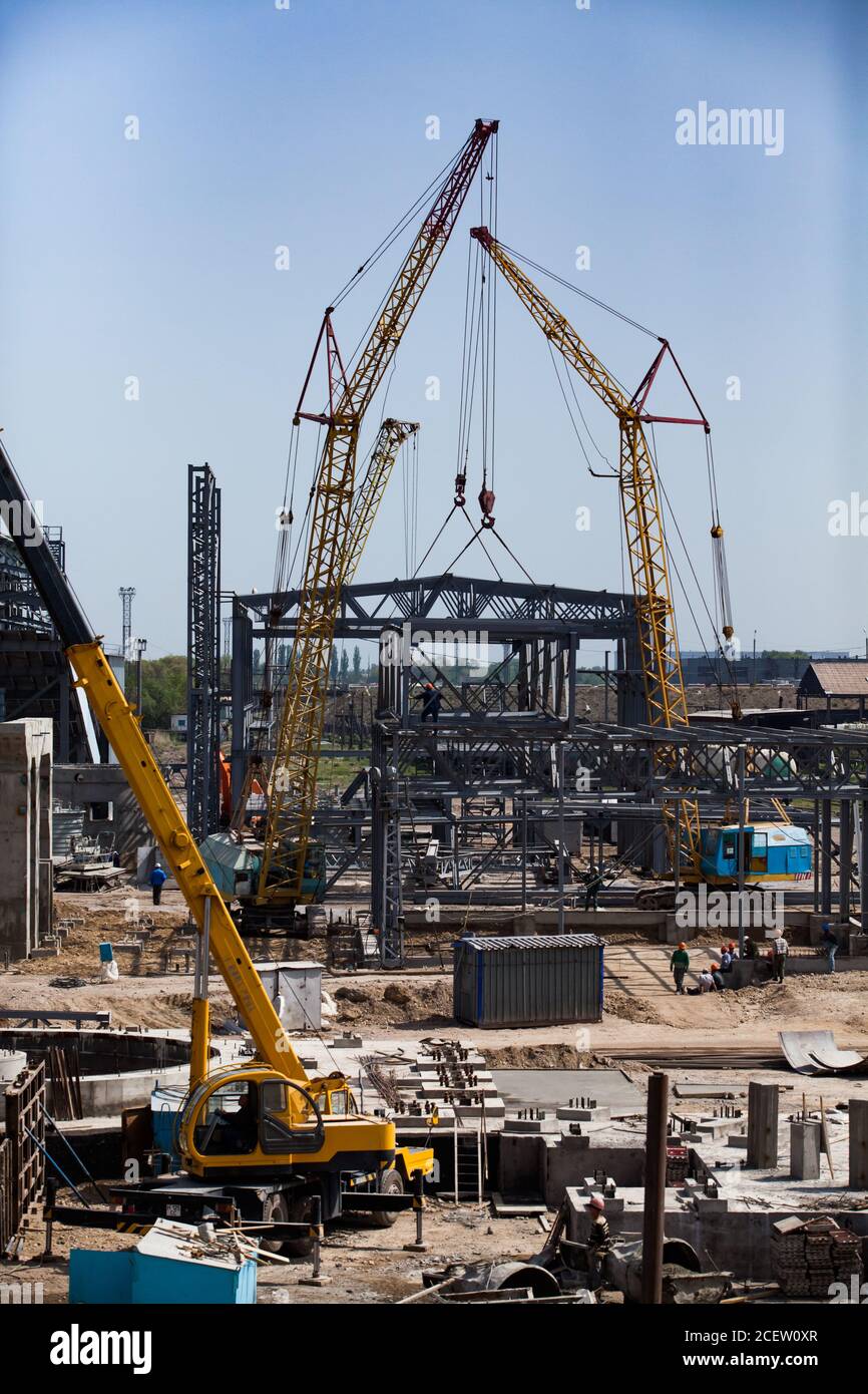 Construction and modernization of fertilizers plant. Yellow girder cranes assembling metal