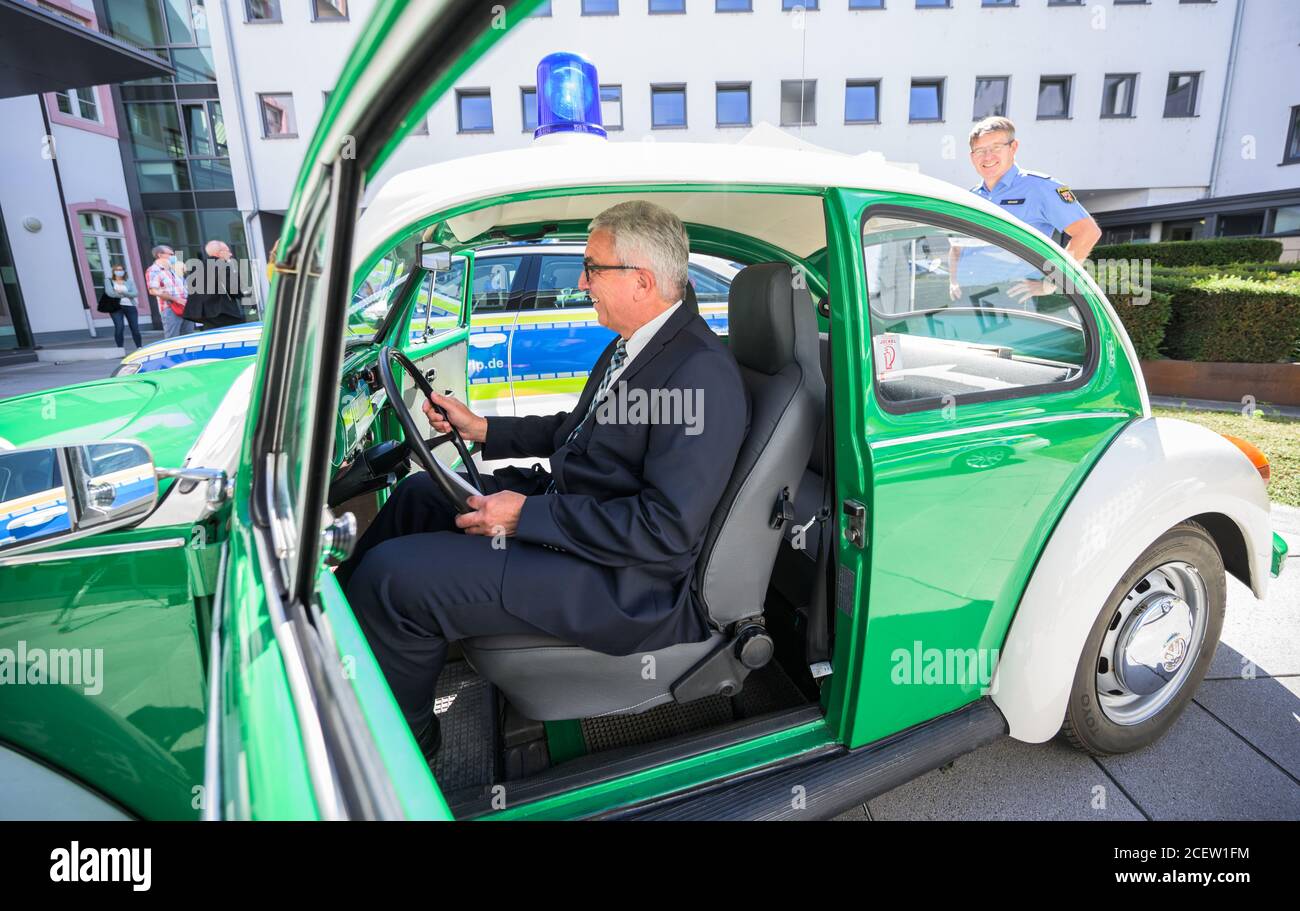 Mainz, Germany. 02nd Sep, 2020. Roger Lewentz (SPD), Minister of the Interior of Rhineland-Palatinate, sits in a historic police emergency vehicle, a VW Beetle from 1976, and the Minister presents the future police emergency vehicles. The police vehicle is an Audi A 6 with a new visual appearance. Credit: Andreas Arnold/dpa/Alamy Live News Stock Photo