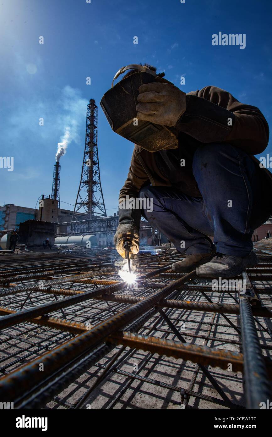 Taraz fertilizers plant. Construction of reinforcement concrete foundation or basement. Welder