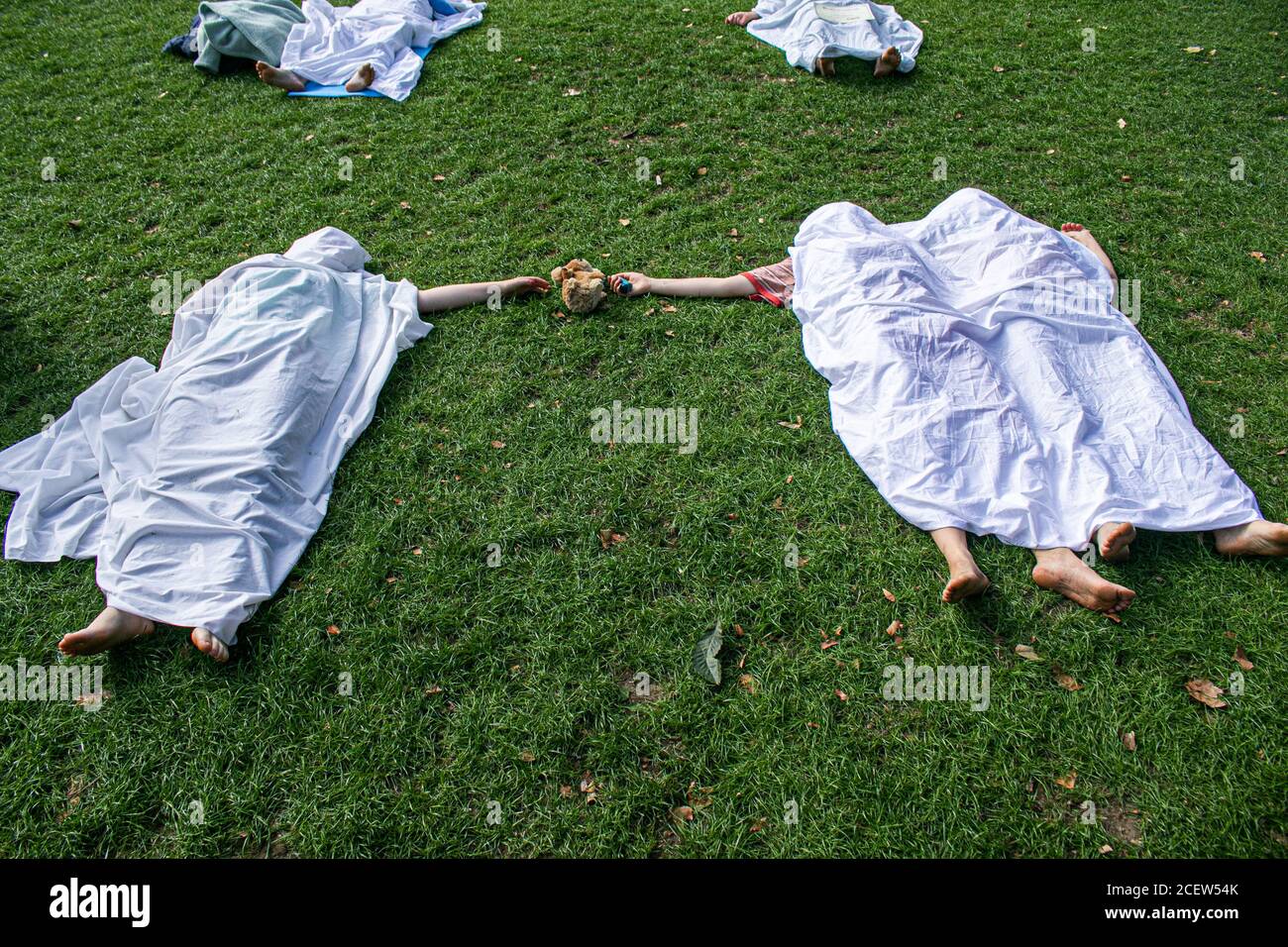 WESTMINSTER LONDON, UK - 2 September 2020 Climate activists from Extinction rebellion lying as a dead body under a white shroud  in Parliament Square. Extinction Rebellion have vowed  to continue protests over 12 days in London  due to the government’s failure to act on the climate and ecological emergency and demand the government act now  and to support the Climate and Ecological Emergency Bill. Credit: amer ghazzal/Alamy Live News Stock Photo