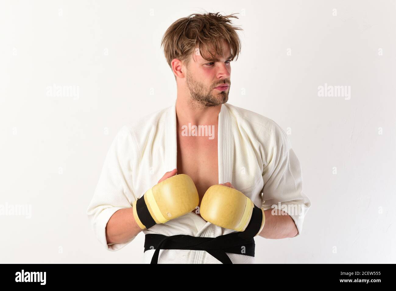 Man with curious face and bristle on white background. MMA fighter with  strong body practices martial