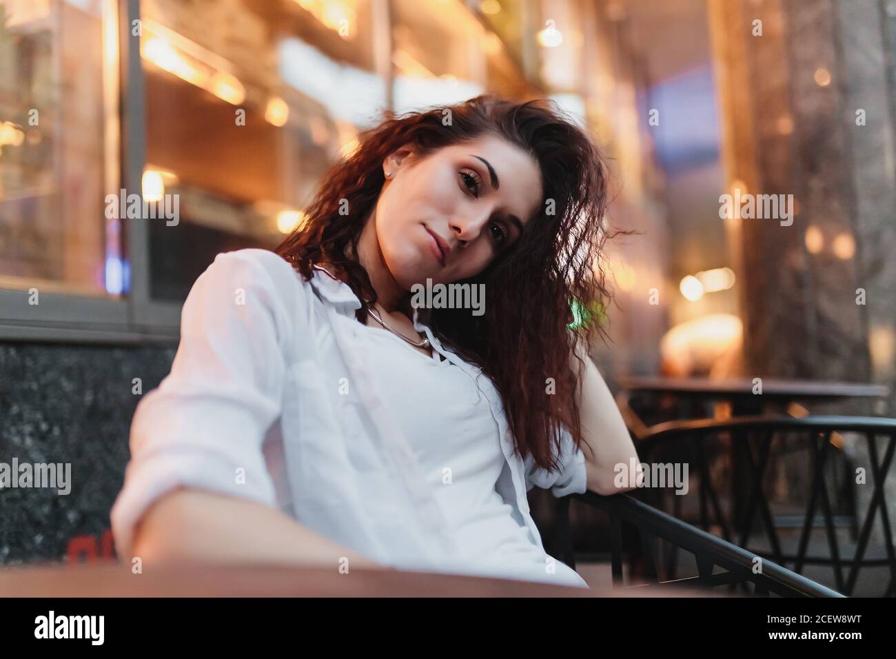 Woman sitting on the terrace in the summer evening Stock Photo - Alamy
