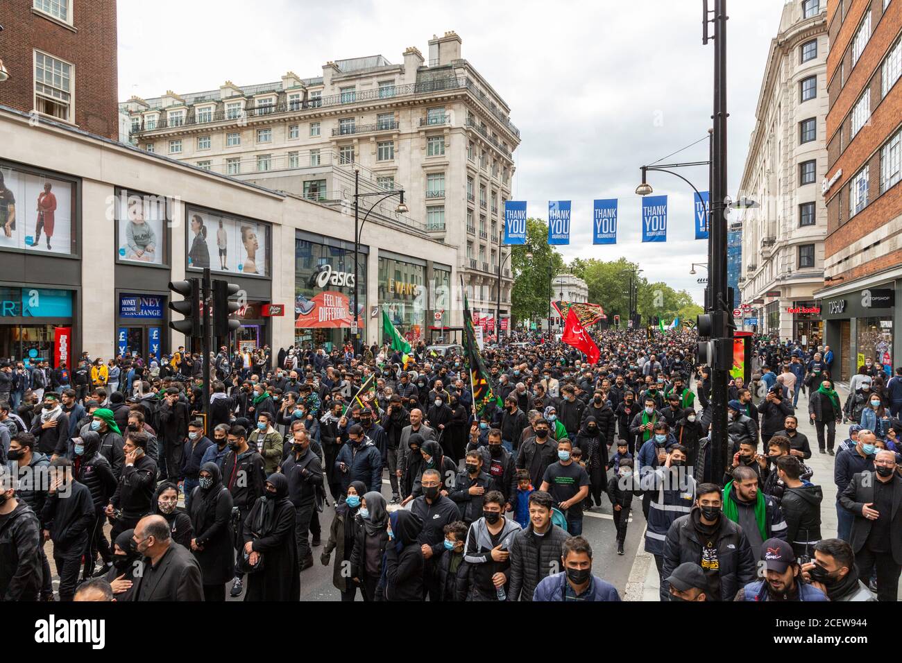 Crowd marching on Oxford Street during Ashura Day event for Shia Muslims, London, 30 August 2020 Stock Photo