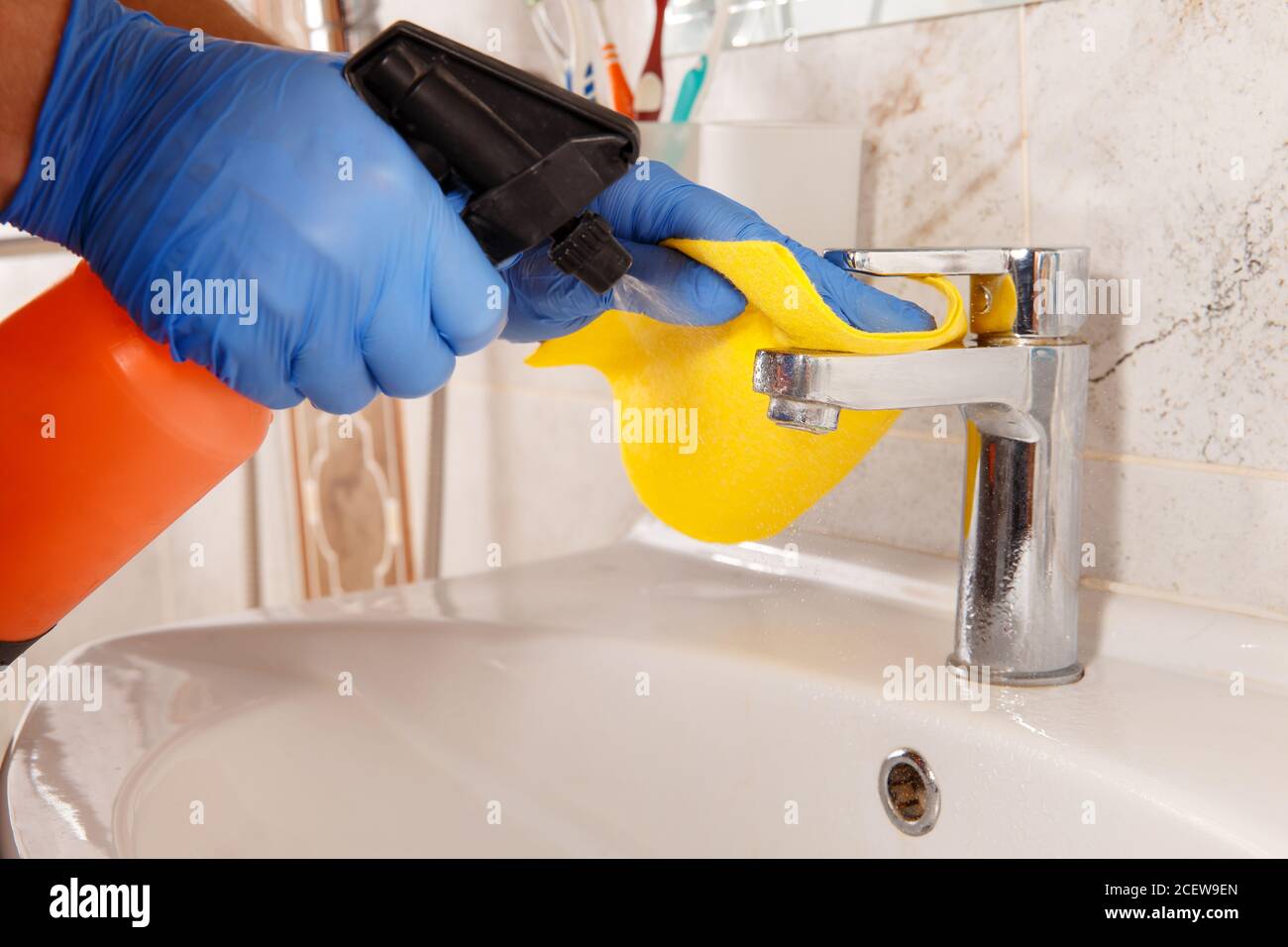 Cleaning chrome bathroom elements with a special tool for removing ...