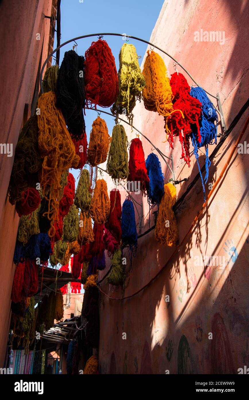 Skeins of coloured wool draped from rafters in the Souk des Teinturiers, the dyer's souk  within the Medina,  Marrakesh Stock Photo