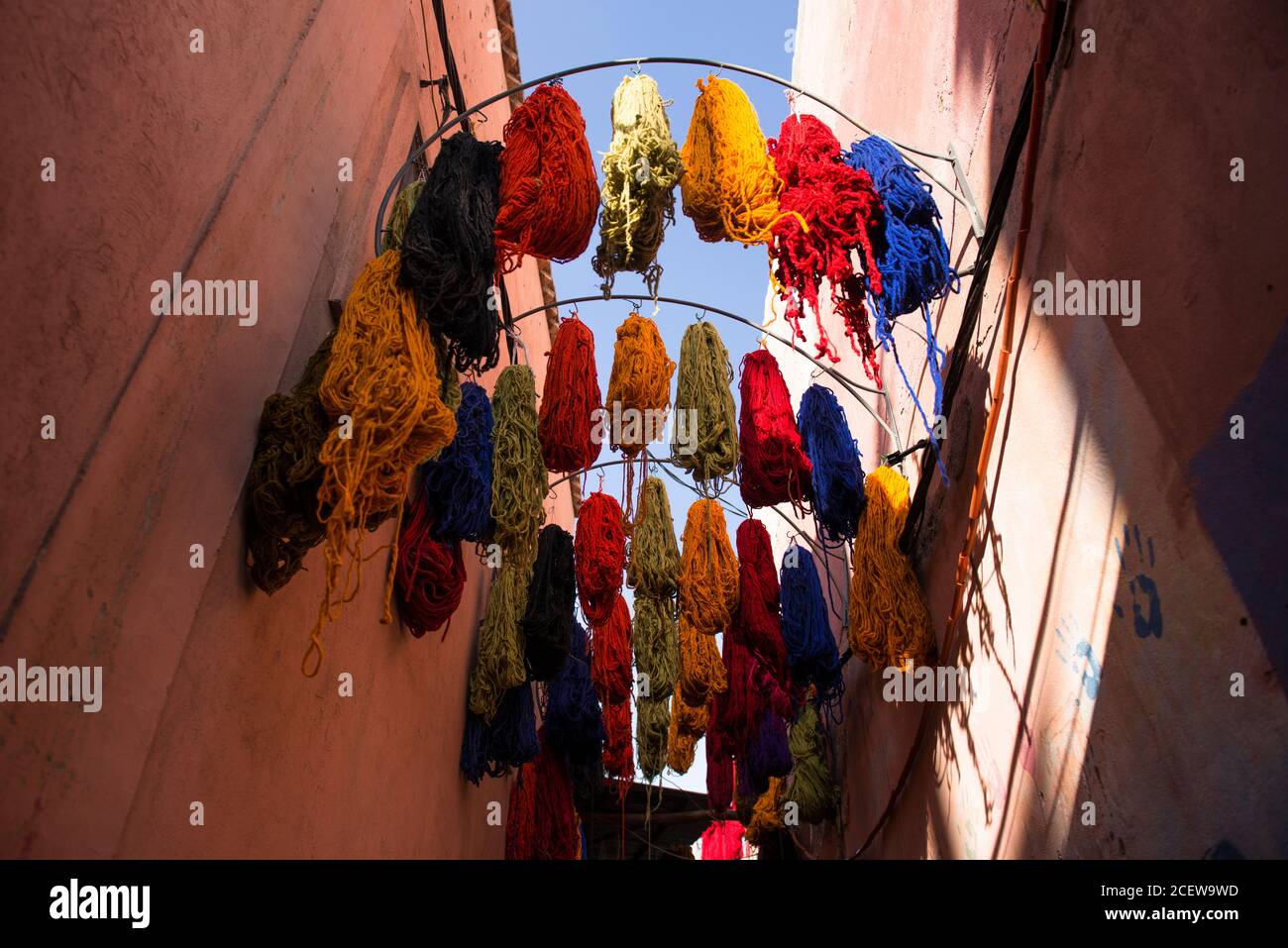 Skeins of coloured wool draped from rafters in the Souk des Teinturiers, the dyer's souk  within the Medina,  Marrakesh Stock Photo