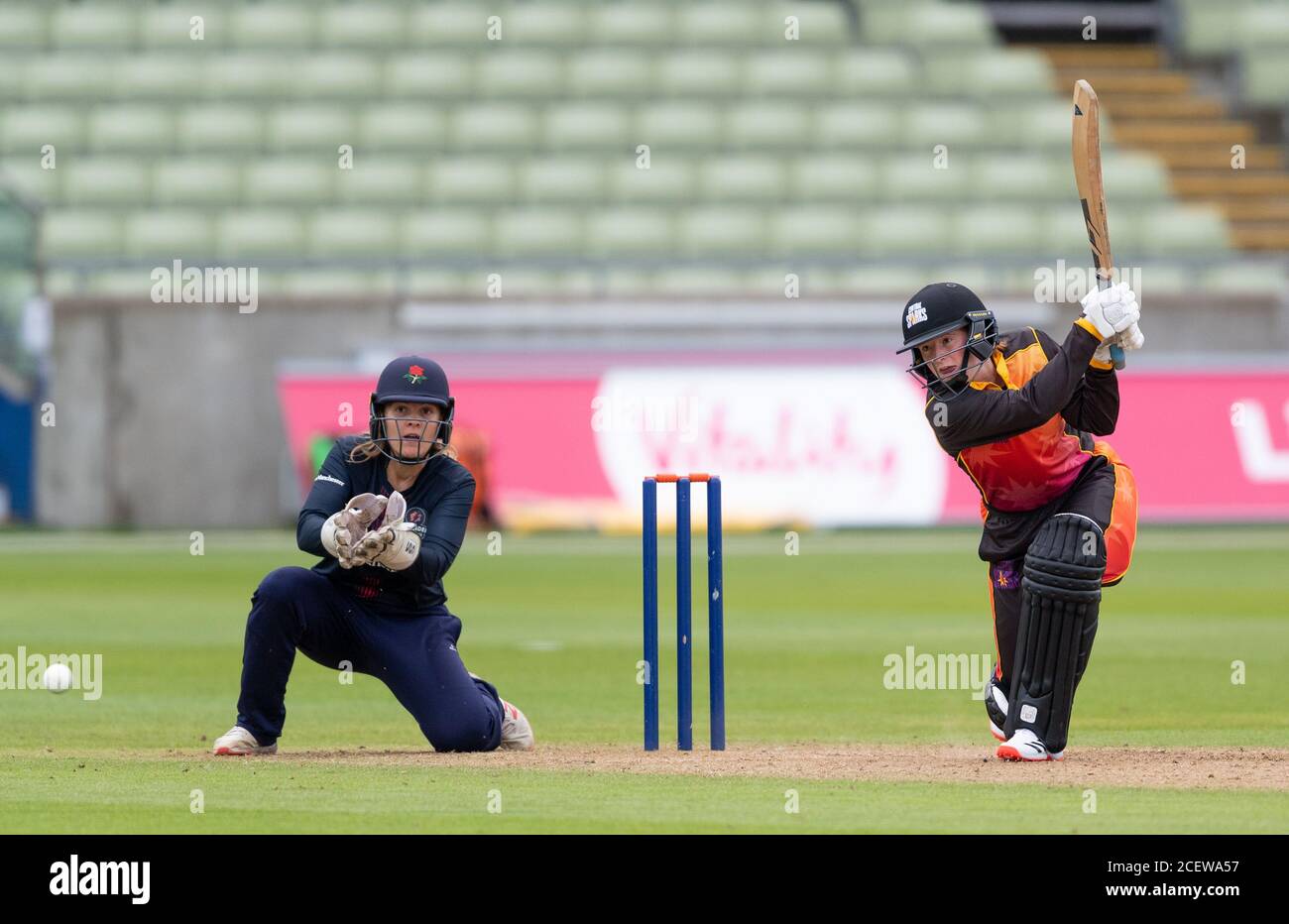 Milly Home batting for Central Sparks watched by Thunder's wicket keeper Ellie Threlkeld n a Rachael Heyhoe Flint Trophy match Stock Photo