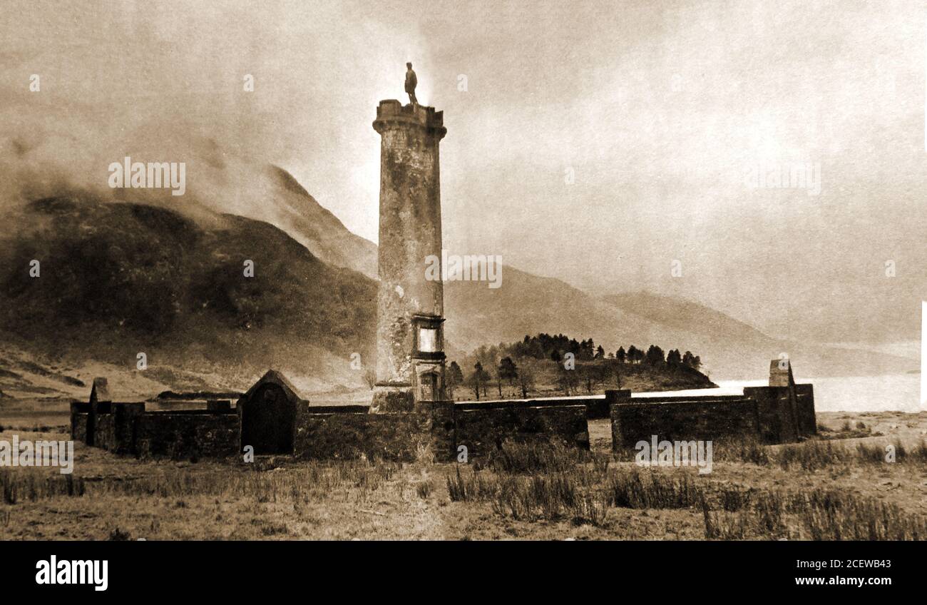 An old (1933) vintage photograph showing the Bonnie Prince Charlie monument Glenfinnan ( at Loch Shiel Scotland.) Soon  before the Battle of Culloden, Prince Charles Edward Stuart raised his father’s Standard at Glenfinnan, marking the start of the 1745 Jacobite campaign.  This 18 meters high monument with a lone kilted highlander on top was built here in 1815,as a memorial to   the clansmen who gave their lives to the Jacobite cause. There is now a modern visitor centre also and a railing  is provided around the clansman figure. Stock Photo
