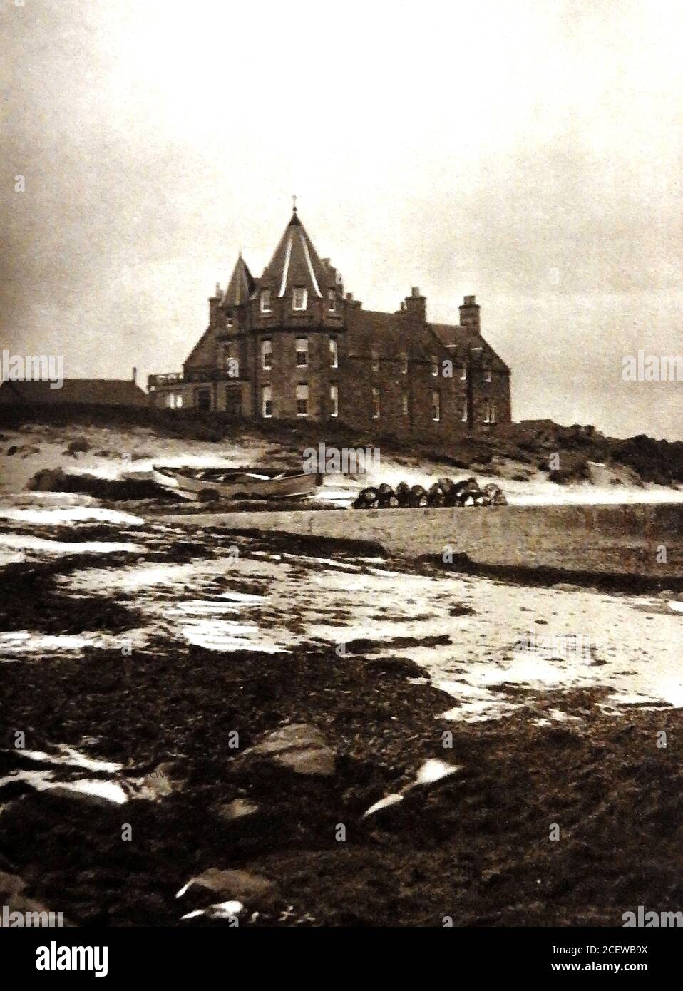 An old 1933 photograph of the  Seaview hotel at John O Groats, Scotland, (now the John o' Groats House Hotel / The Inn At John O’Groats) seen from the beach. John O'Groats  takes its name from  Jan de Groot, a 16th century Dutchman who once operated a ferry from the Scottish mainland to Orkney.In British culture, John O'Groats is linked with  Land's End (Cornwall) being at the extreme opposite end of the country. Bikers, walkers, motorists etc, often make the symbolic journey (either way) as a kind of non-religious pilgrimage, sometimes in order to raise cash for charity fundraising Stock Photo