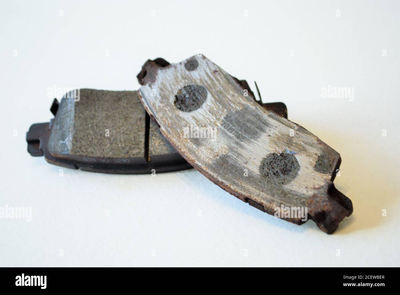 Worn out ruined disc brake pad compared to one that is new Stock Photo