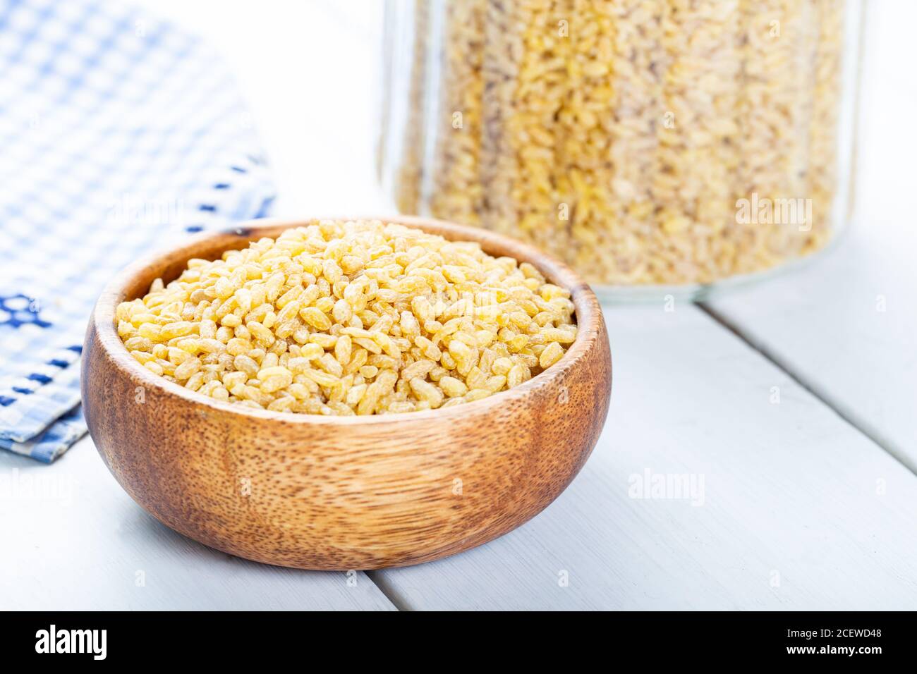 Raw uncooked bulgur wheat grains in a bowl close up Stock Photo - Alamy