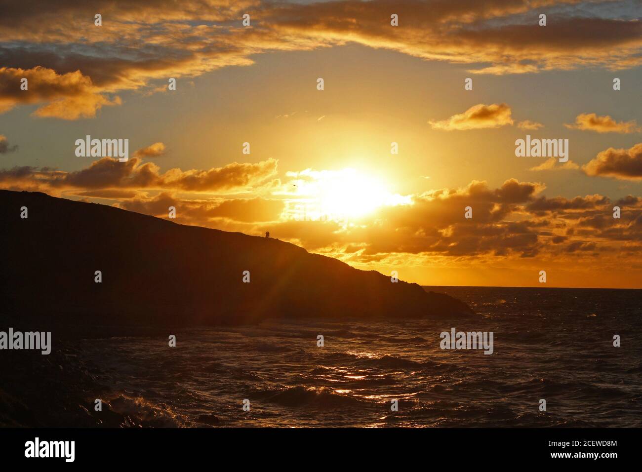 Beautiful scenery of the sunlit sea with a golden sunset over the ...
