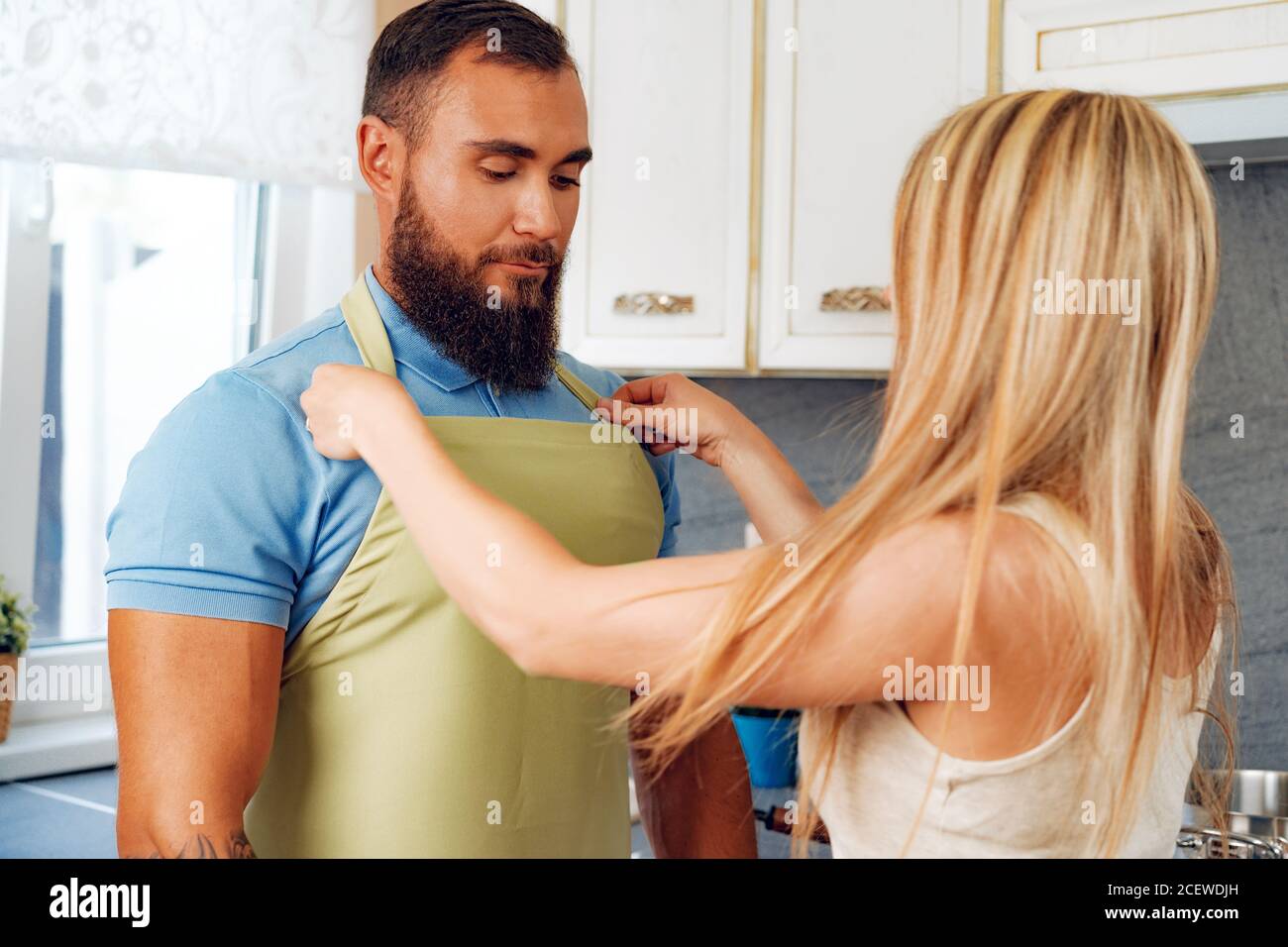 Woman putting apron on hi-res stock photography and images - Alamy
