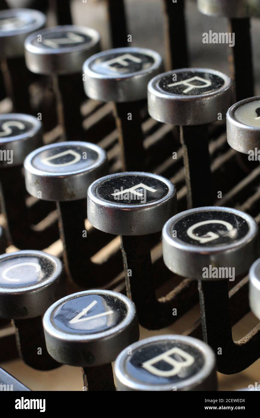 Extreme close up image of vintage azerty typewriter keys, with the letter F centered. Selective focus. Stock Photo