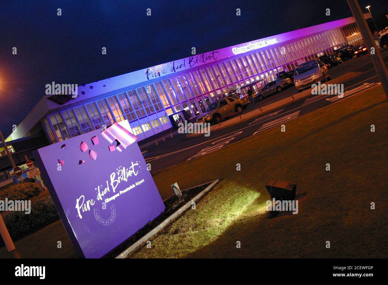 Glasgow Prestwick Airport, Ayrshire, Scotland. 19 May 2005. Exterior floodlit terminal building at the rebranding party. The branding by the owners New Zealand Compnay Infratel was and is controversial using the tag line ' Pure Dead Brilliant ' The airport has been nationlised by the Scottish goverment Stock Photo