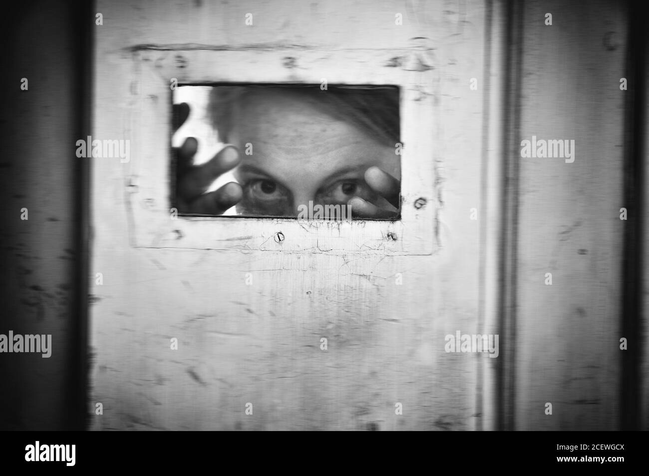 Black and white image of crazy woman at old mental hospital. Stock Photo