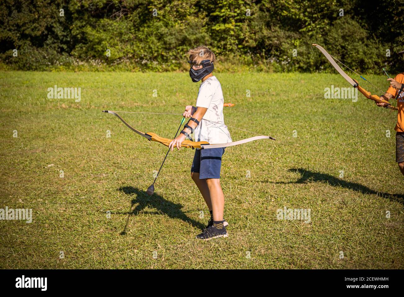 Boy Preparing For An Attack While Playing Archery Stock Photo Alamy