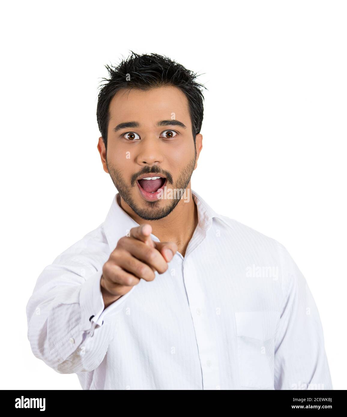 Closeup portrait of a handsome young man pointing with index finger feeling stunned, dumbstruck, dumbfounded, looking at camera isolated on white back Stock Photo