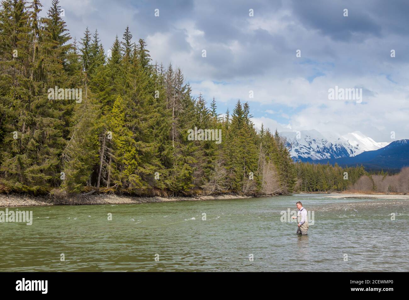 a fisherman fishing for Steelhead on a river in the Skeena Region of British Columbia Canada Stock Photo