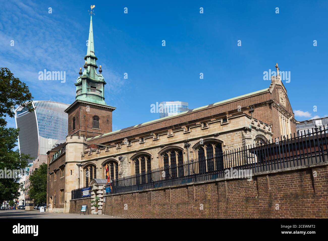 All Hallows-by-the-Tower church in the City of London, UK, with the Walkie Talkie Tower in the background Stock Photo