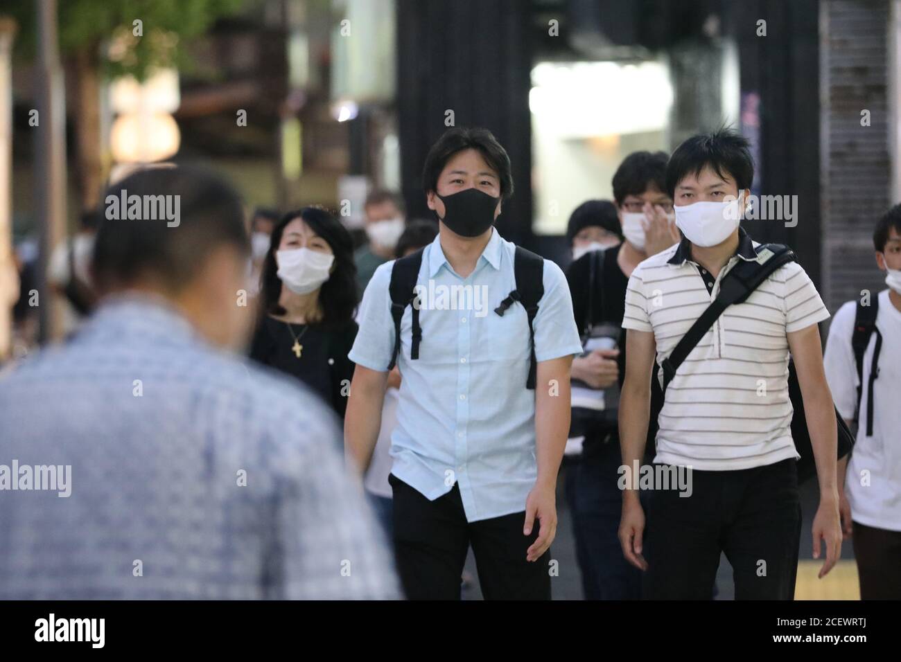 Tokyo, Japan. 2nd Sep, 2020. People wearing face masks walk on the street in Tokyo, Japan, on Sept. 2, 2020. Japan on Wednesday reported 592 new coronavirus cases, dropping from 633 new infections confirmed the previous day and bringing the nation's cumulative COVID-19 tally to 69,743, not including those related to a cruise ship quarantined in Yokohama near Tokyo earlier in the year. Credit: Du Xiaoyi/Xinhua/Alamy Live News Stock Photo