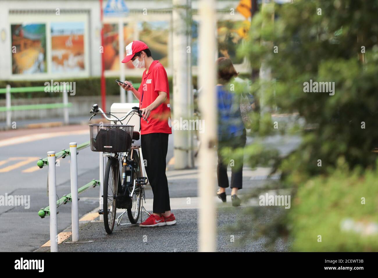 Tokyo, Japan. 2nd Sep, 2020. A take-away deliveryman checks the order information on a cellphone in Tokyo, Japan, Sept. 2, 2020. Japan on Wednesday reported 592 new coronavirus cases, dropping from 633 new infections confirmed the previous day and bringing the nation's cumulative COVID-19 tally to 69,743, not including those related to a cruise ship quarantined in Yokohama near Tokyo earlier in the year. Credit: Du Xiaoyi/Xinhua/Alamy Live News Stock Photo