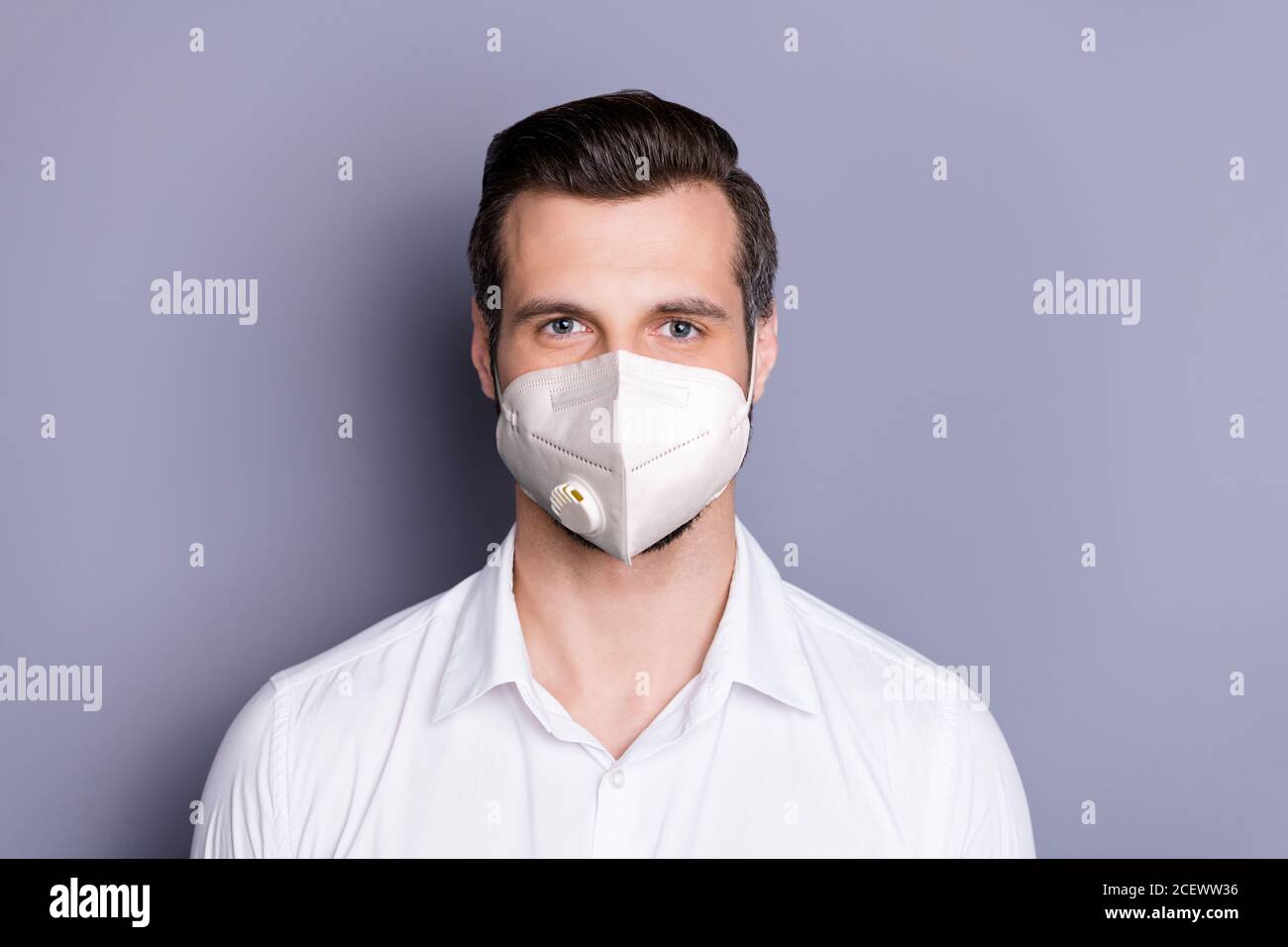 Close-up portrait of his he attractive healthy guy wearing safety mask stop respiratory disease contamination infection influenza medicine flu flue Stock Photo