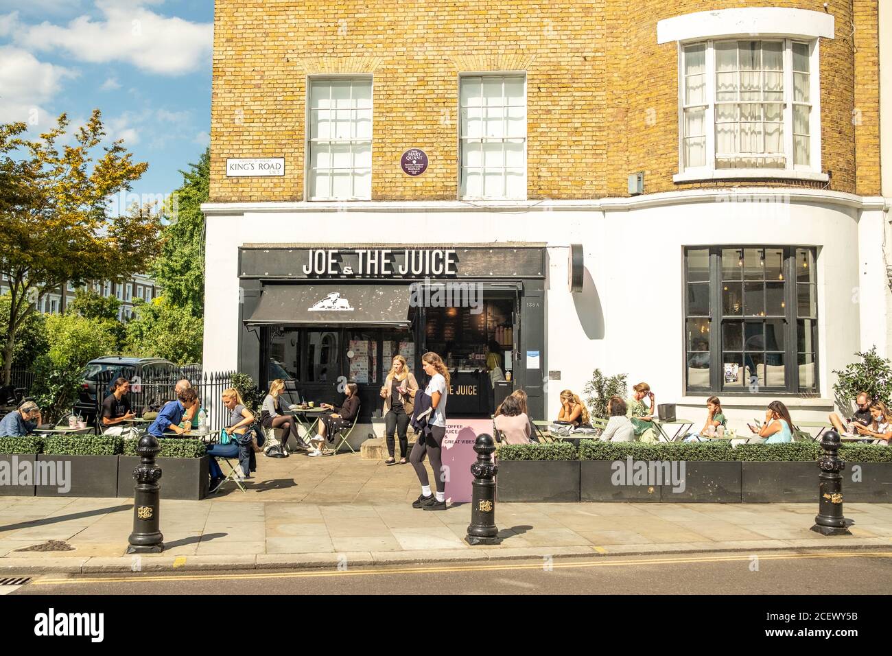 London People sitting outside at a Joe & The Juice store on the Kings