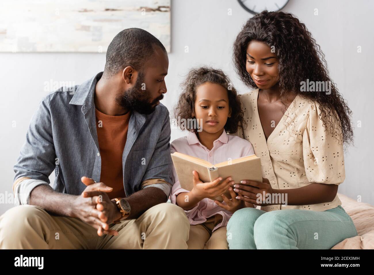 young african american husband and wife sitting near concentrated ...
