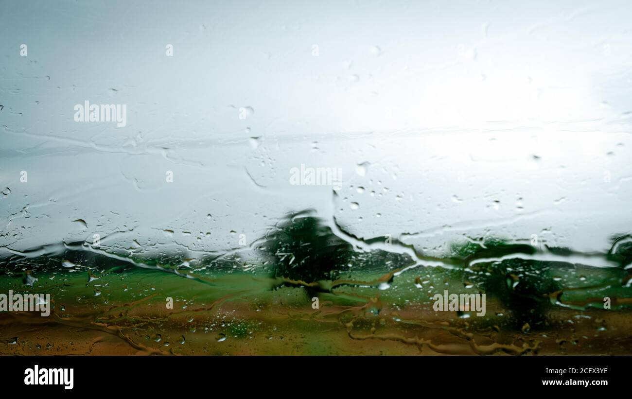 View through the car window in the rain. Rainy weather through the car