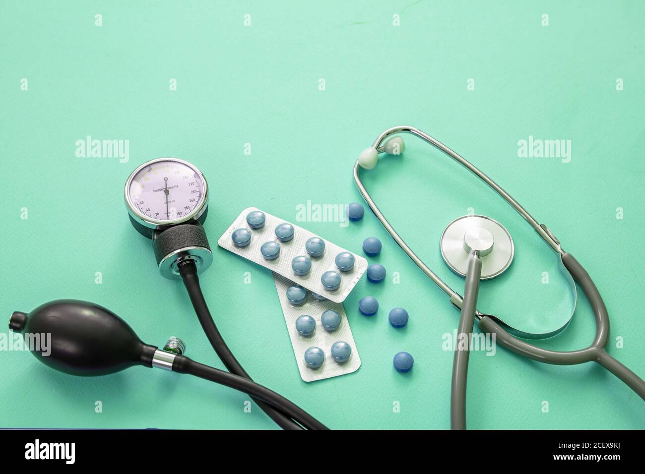 https://c8.alamy.com/comp/2CEX9KJ/blood-pressure-meter-medical-stethoscope-and-medicine-on-pastel-green-blue-color-background-close-up-view-hypertension-treatment-medication-concep-2CEX9KJ.jpg