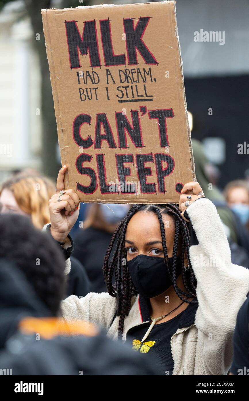 A girl holding a protest sign above her head at the Million People March, London, 30 August 2020 Stock Photo