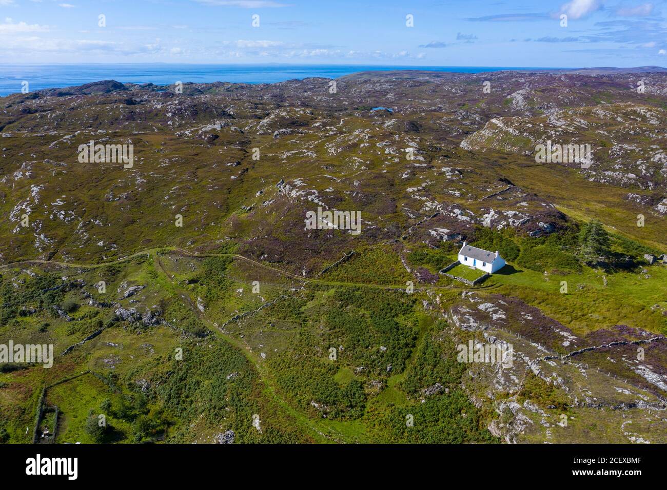 Solitary white cottage in wild landscape of Assynt near Clachtoll, north west Highlands, Scotland, Uk Stock Photo