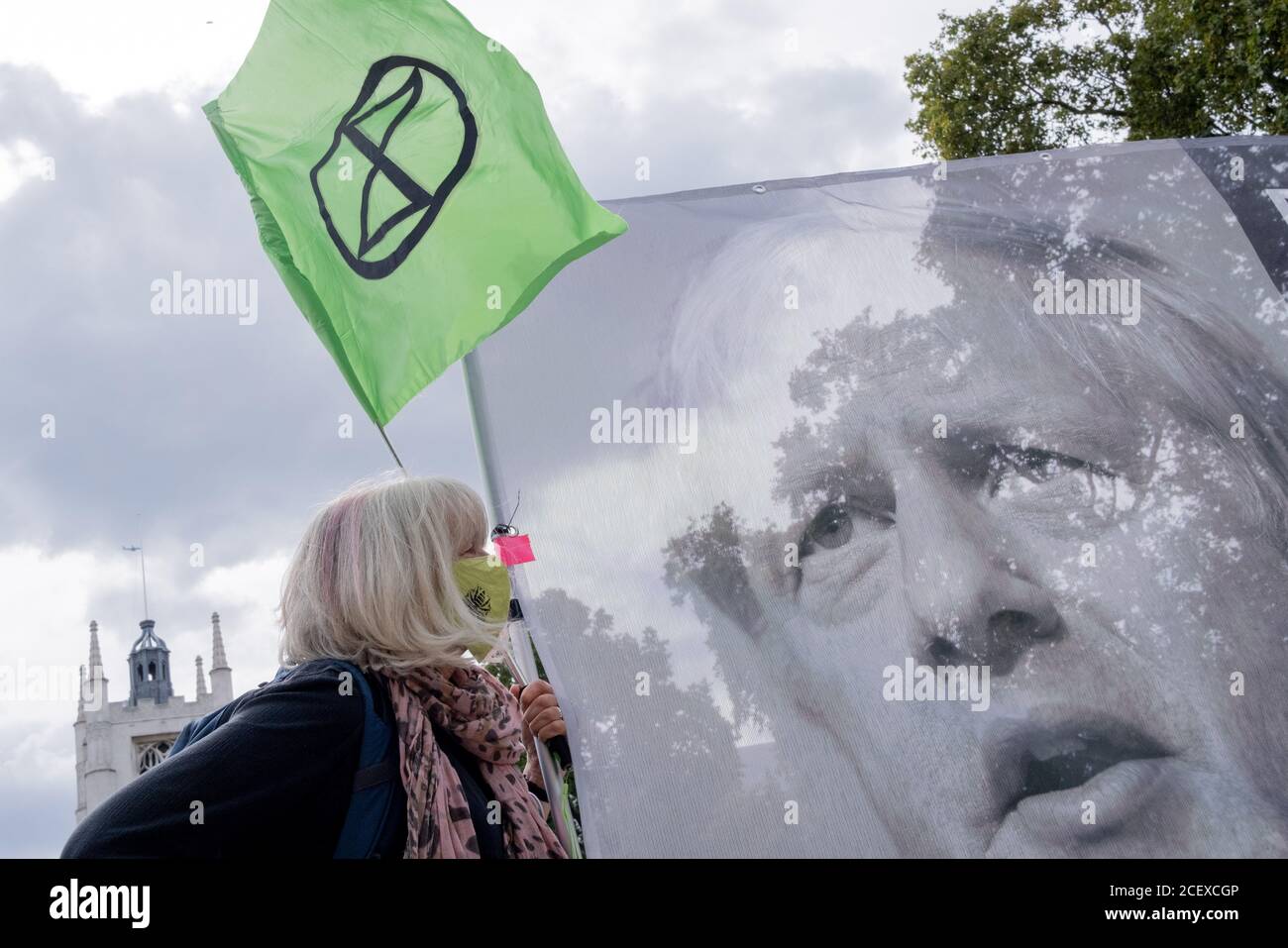 After a postponed break because of the Coronavirus pandemic,  Climate Change activists protest with a banner featuring the image of Prime Minister Boris Johnson in Parliament Square, on 2nd September 2020, in London, England. Stock Photo