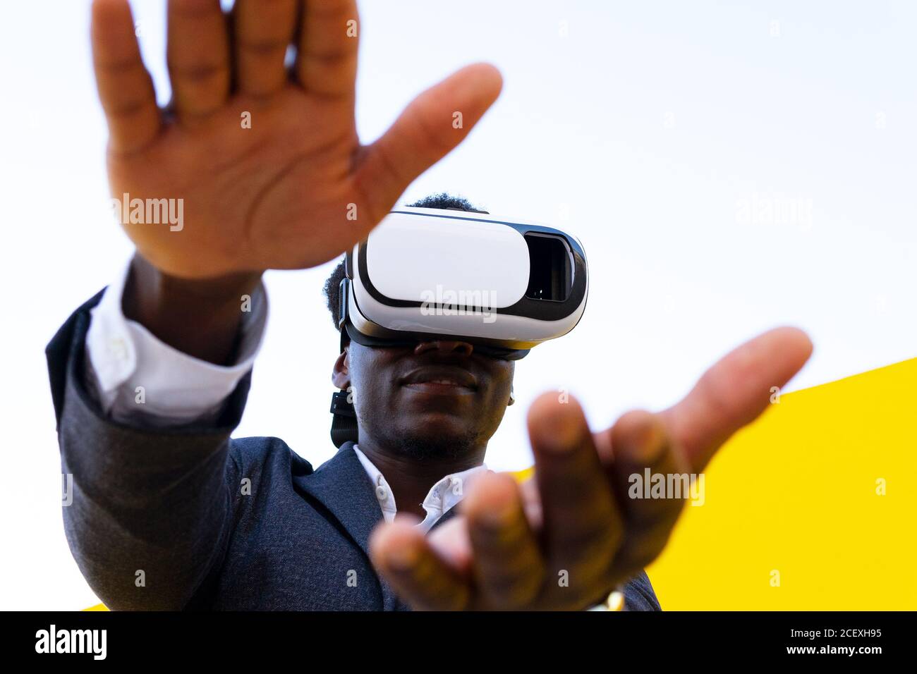 African American male standing experiencing virtual reality while using ...