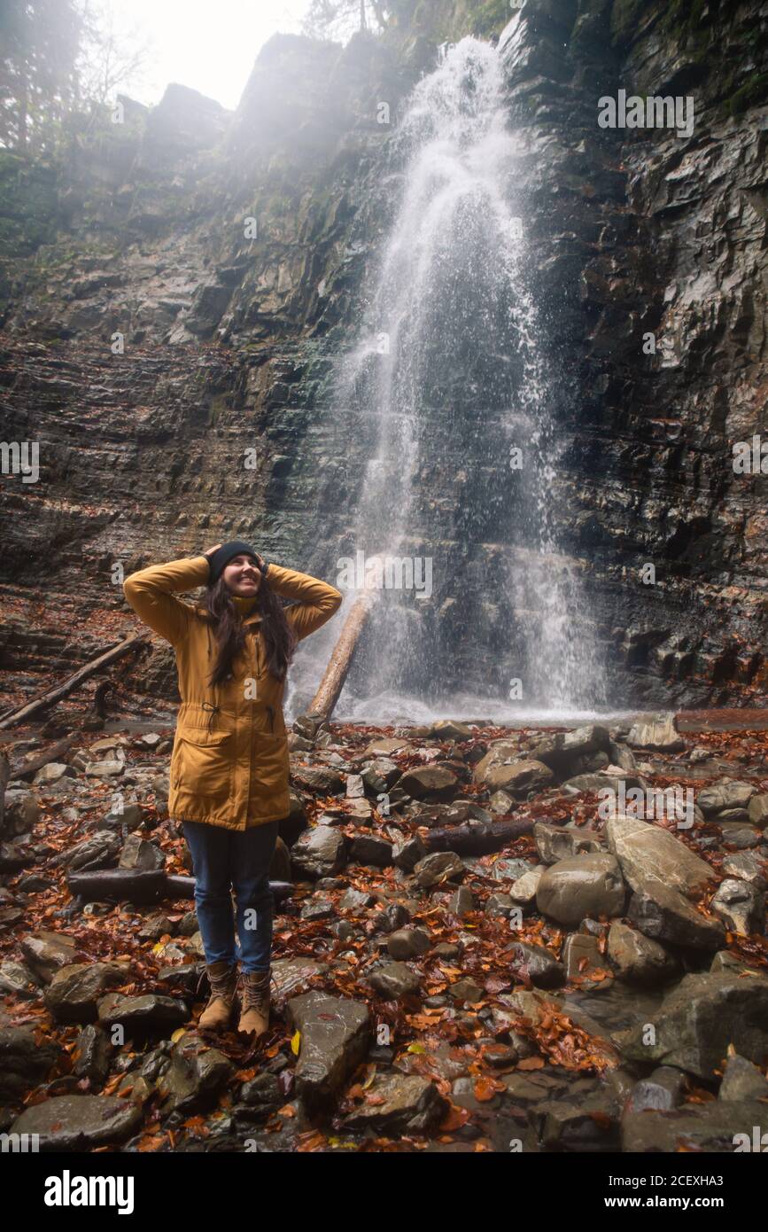 woman near waterfall in forest autumn season Stock Photo - Alamy