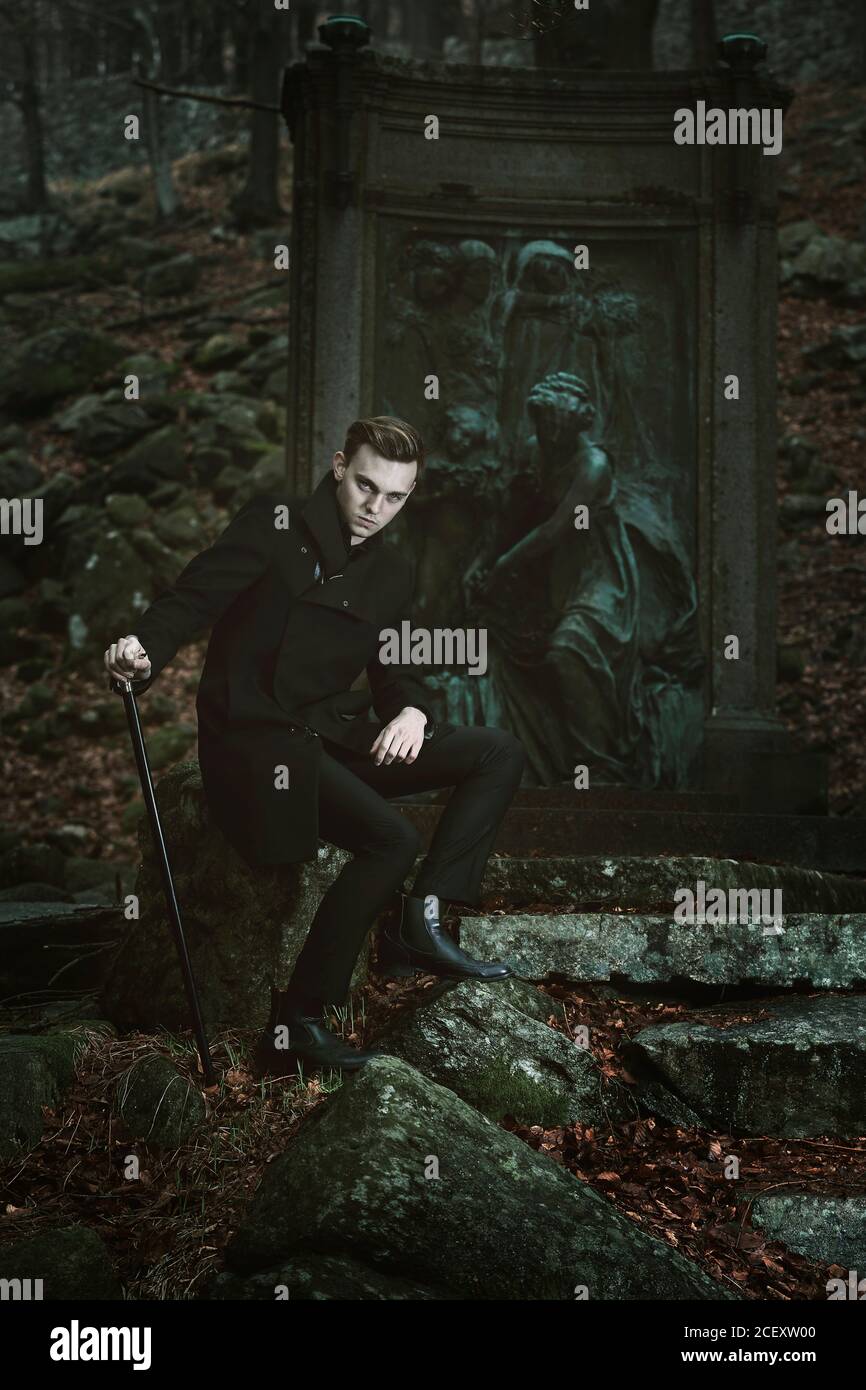 Handsome vampire posing in a cemetery Stock Photo