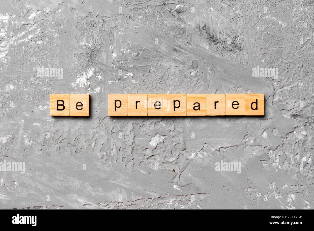BE PREPARED word written on wood block. BE PREPARED text on cement ...