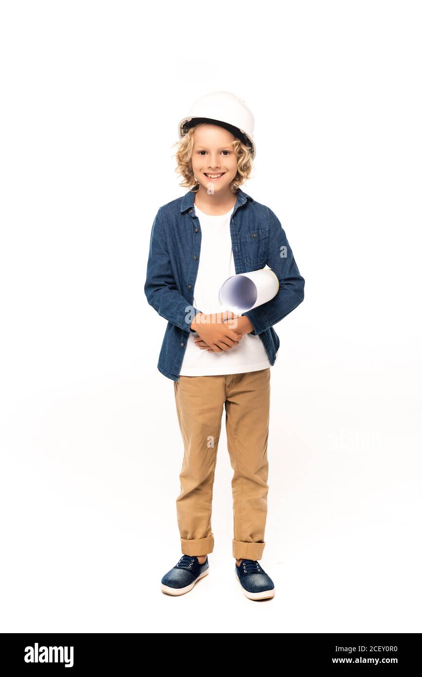 curly boy in safety helmet and costume of architect holding blueprint