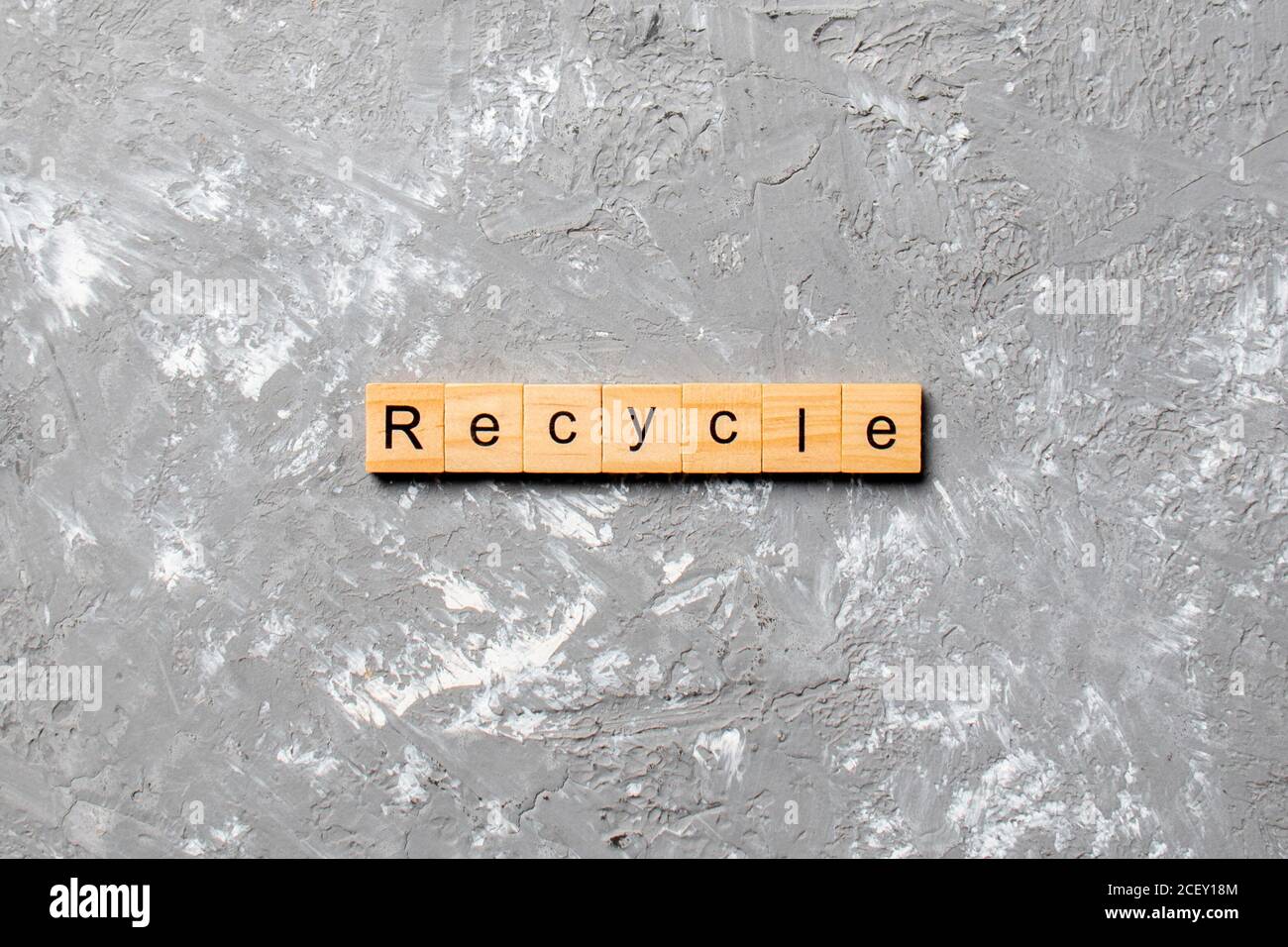 recycle word written on wood block. recycle text on cement table for ...