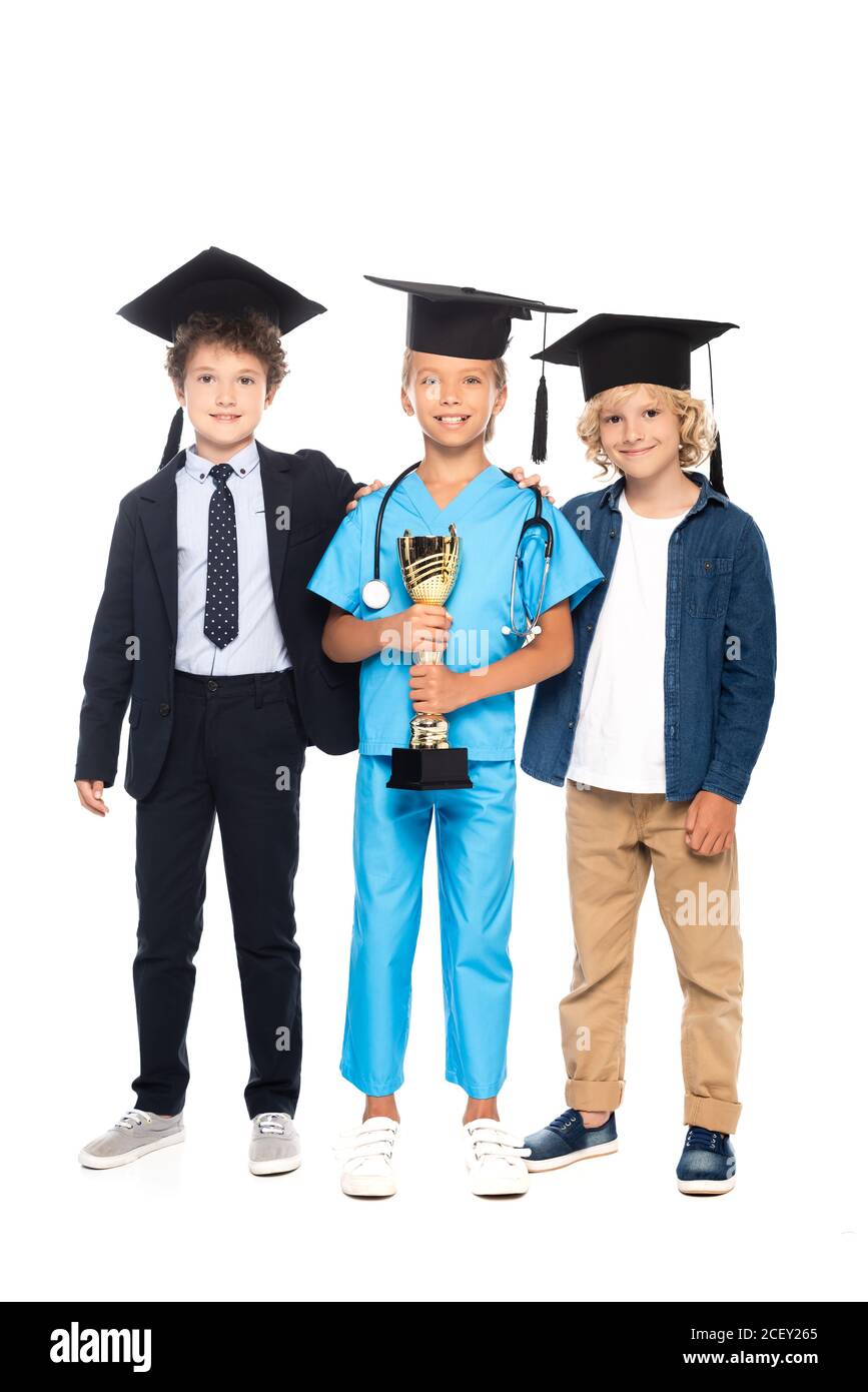 children in graduation caps dressed in costumes of different