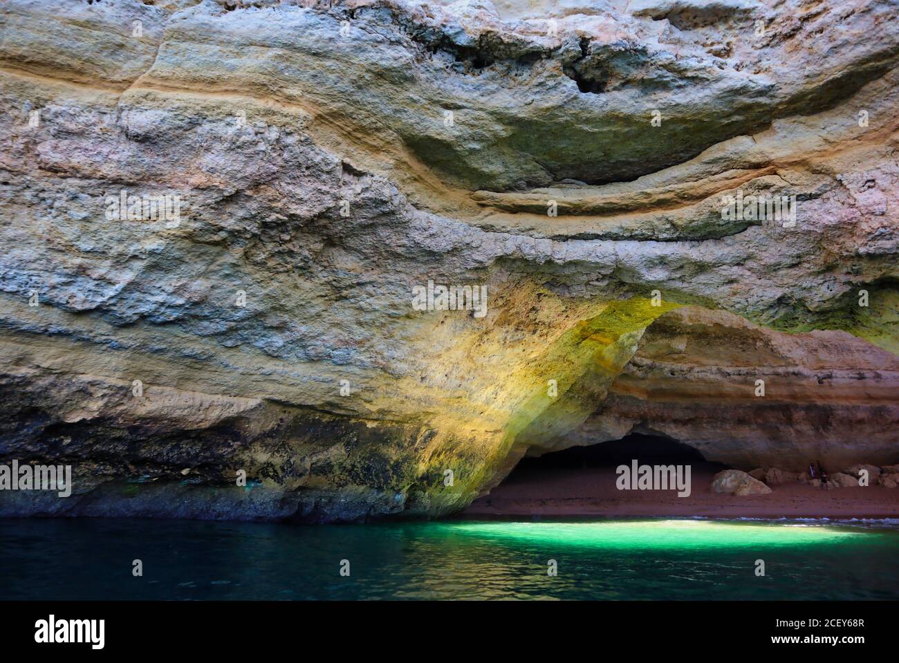 Benagil cave picture taken from a boat with a view of light coming out from the hole up in the cave. Stock Photo