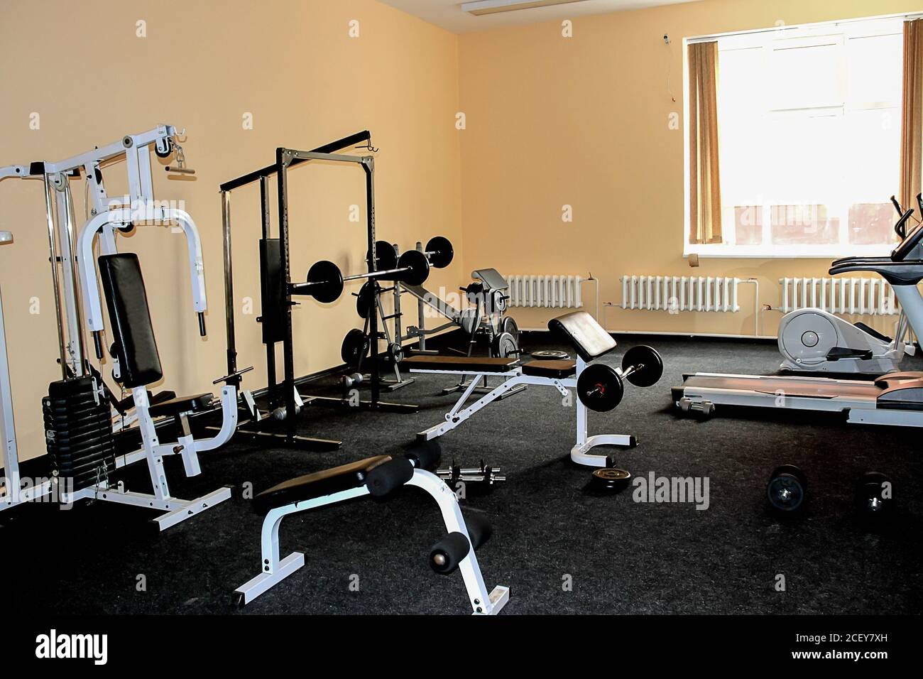 Small gym room with exercise equipments. House interior. Sport, fitness, amateur home gym. Stock Photo
